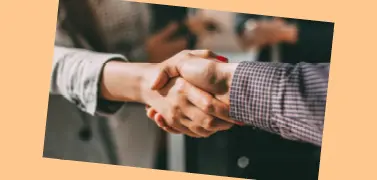 A handshake between two people on an orange background.