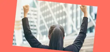A woman in an office attire with her hands raised up on an orange background.