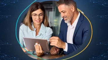Two people looking at a tablet together