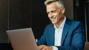 man checking references from his laptop