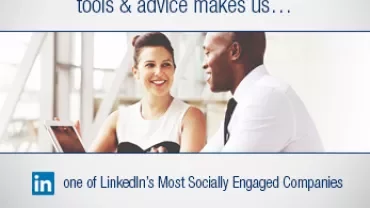Two people conversing in an office setting with LinkedIn logo.