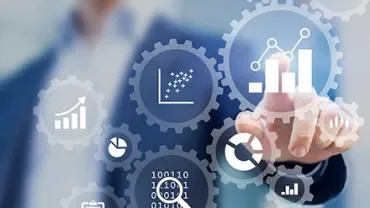 Person pointing at digital graphs and gears.