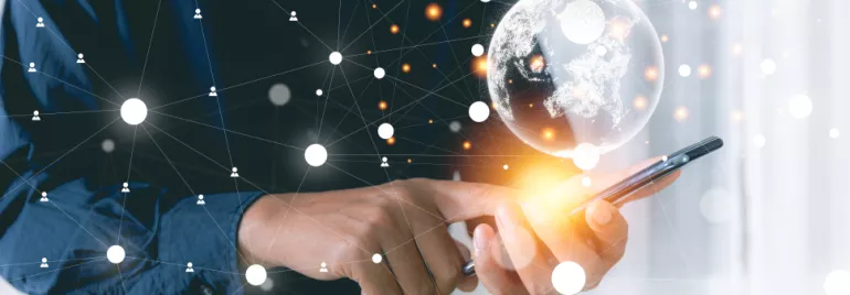Person using a smartphone with digital globe and network connections.