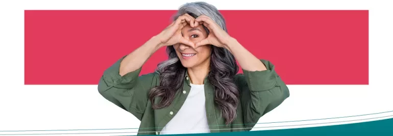 Person shaping a heart with hands and smiling
