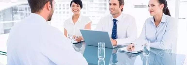 Business meeting in an office with four people around a table
