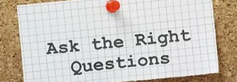 Corkboard with a note saying 'Ask the Right Questions'.