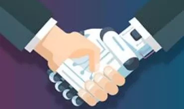 A human hand shaking hands with a robotic hand.