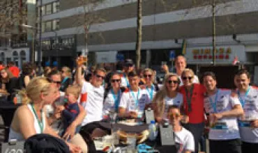 A group of people celebrating outdoors at a café.
