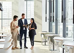 3 people talking in an office setting