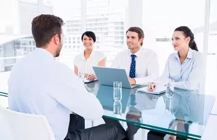 Business meeting in an office with four people around a table