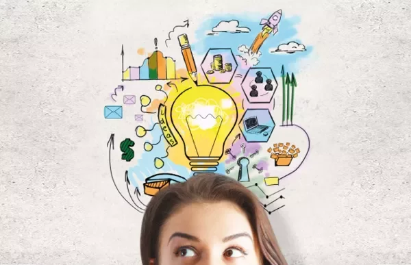 Person with doodles of a lightbulb and ideas overhead.