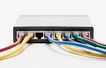 Network switch with colored cables plugged in.