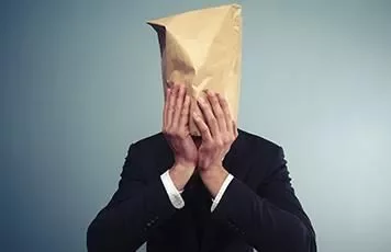 Individual with a paper bag over their head